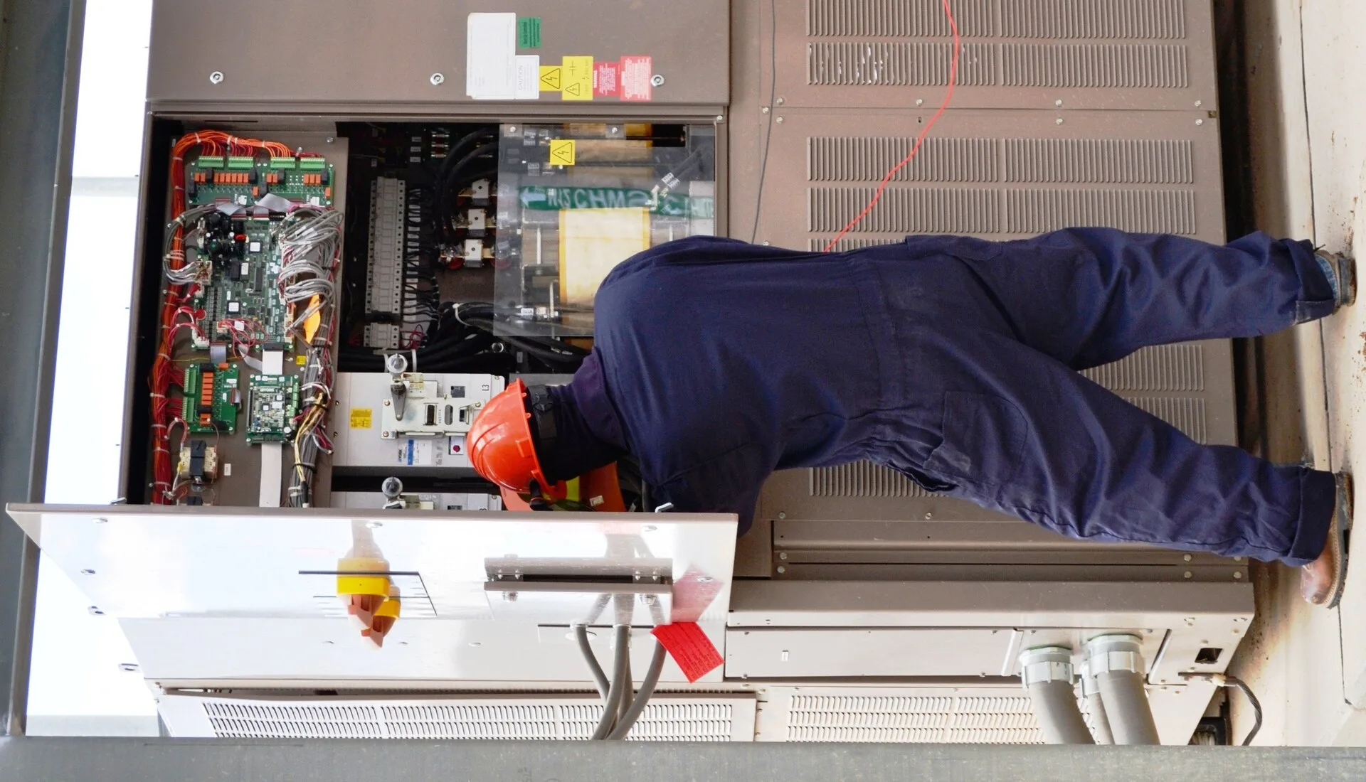A Pueblo Chemical Agent-Destruction Pilot Plant master electrician checks the Chiller Water System control panel for zero energy before working on equipment. Arc-flash rated clothing, such as the one worn in this photo, is necessary when working with high voltage electrical systems. Staffing an electrical contractor business properly for 2027